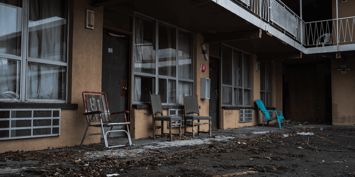 Motel exterior showing run-down conditions - inadequate property maintenance can indicate security neglect